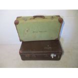 Two vintage suitcases, one marked with the name Mr.J.Phillips.