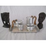 A pair of African carved busts along with a Picquot ware tea set on tray