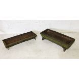 Two small cast iron troughs