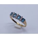 A 9 ct gold dress ring set with topaz and CZ