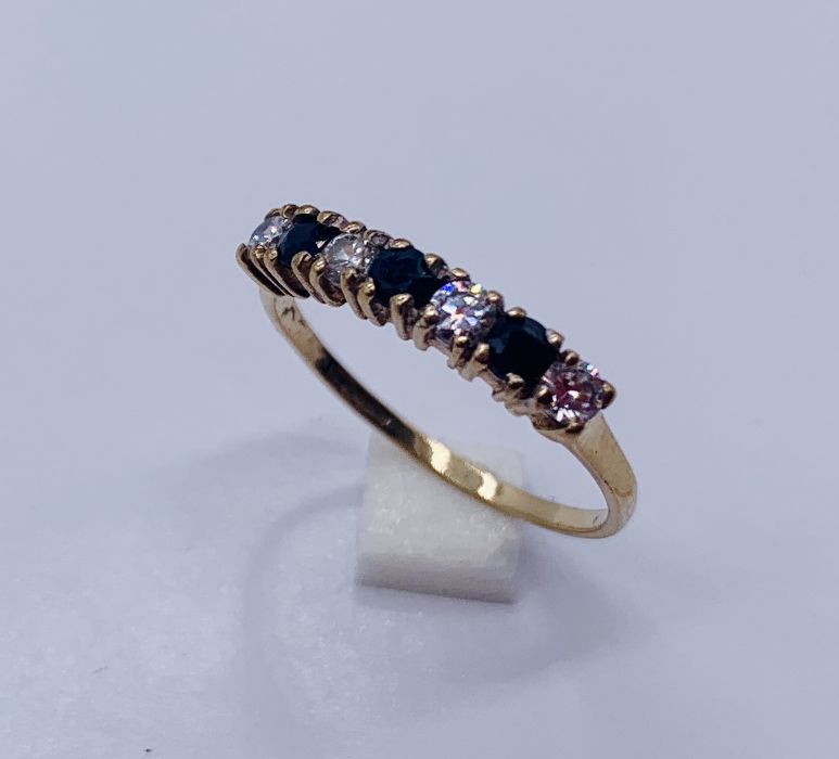 A diamond and sapphire 7 stone ring set in 9ct gold