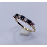 A diamond and sapphire 7 stone ring set in 9ct gold