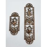 Two ornate brass pierced fingerplates depicting musical instruments