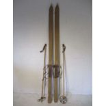A set of vintage wooden skis together with a set of bamboo ski poles