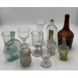 A collection of antique glassware including a bottle marked for "Southwood Axminster" and a number