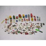 A collection of die-cast and plastic vehicles, along with a selection of tiny plastic toys including