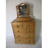 A pine chest of five drawers, along with a pine toilet mirror with single drawer