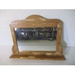 A pine overmantle mirror with shelf