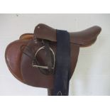An English leather saddle, various tack, saddle rack and a Champion fleece rug