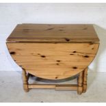 A pine drop-leaf table