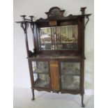 An ornate Art Nouveau marquetry inlaid display cabinet with mirrored back and stained glass