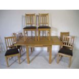 A modern extending dining table, along with six matching dining chairs - table length when