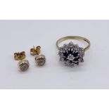 A 9 ct gold dress ring (1 stone missing) along with a pair of 9ct gold earrings - total weight 2.9g