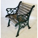 A garden seat with cast iron ends and wooden slatted seat (A/F)
