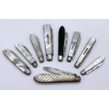 A collection of 9 folding fruit knives with hallmarked silver blades