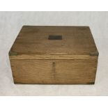 A wooden chest with brass handles and corners labelled Elkington and Co, Regent St London.