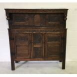 A Jacobean style carved oak court cupboard