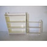 A white painted small freestanding bookcase, along with similar wall hanging shelving unit.