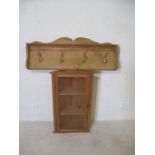 A small glazed pine corner cupboard (height 63cm, width 38cm) and a coat rack.