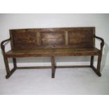 An antique panelled back settle