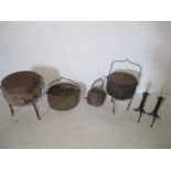 A collection of cast iron pots, kettle and trivets, also a pair of copper fire dogs.