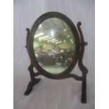 A small oval inlaid toilet mirror