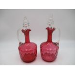 A pair of Victorian cranberry glass decanters