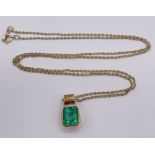 An emerald ( approx 7 mm x 6 mm) set in unmarked gold pendant on a 14 ct gold fine chain, total