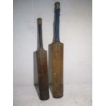 Two vintage cricket bats one is marked Nicolls and stamped J F Anderson, the other is a Gradidge,