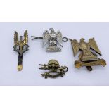 A small collection of cap badges including SAS, Royal Scots Dragoon Guards and 17th Lancers