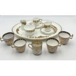 A small collection of gilt china including coffee cups, tea cups, platter etc.