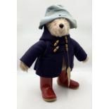 A 1970's Gabrielle Paddington Bear in blue felt hat, Blue duffle coat and red Wellingtons with paper