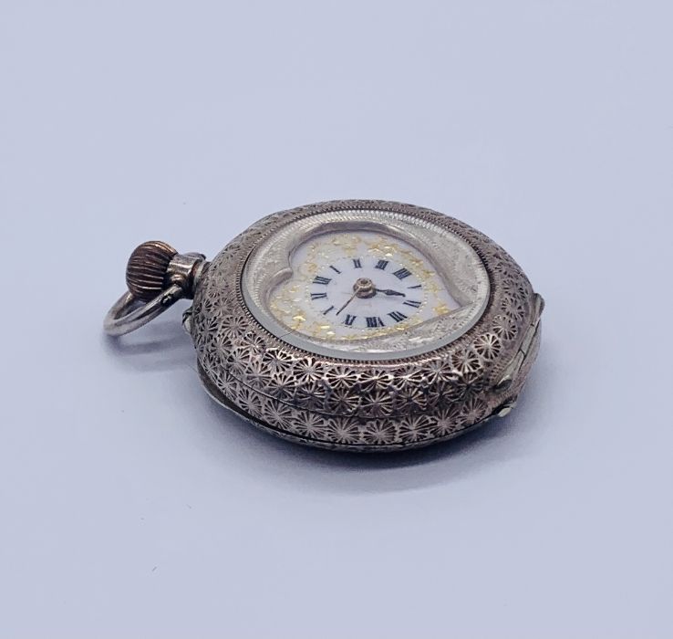 A 935 silver heart shaped fob watch with white enamelled dial with gold decoration