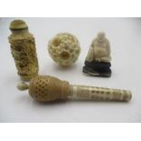 An early 20th century carved 6 layer ivory puzzle ball, figure of a Buddha, resin scent bottle etc.