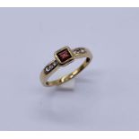 A 9ct gold ring set with a garnet