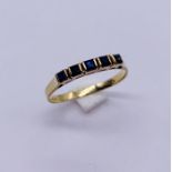 A 9ct gold half eternity ring set with sapphhires