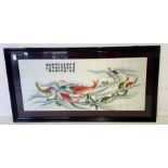 A large framed Oriental embroidery depicting carp 62cm x 120cm