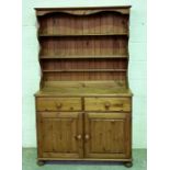 A pine dresser with two drawers and cupboard under - height 189cm depth 44cm width 110cm.
