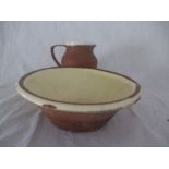 A vintage terracotta dairy bowl with cream glazed interior along with a similar 4 pint jug ( A/F)