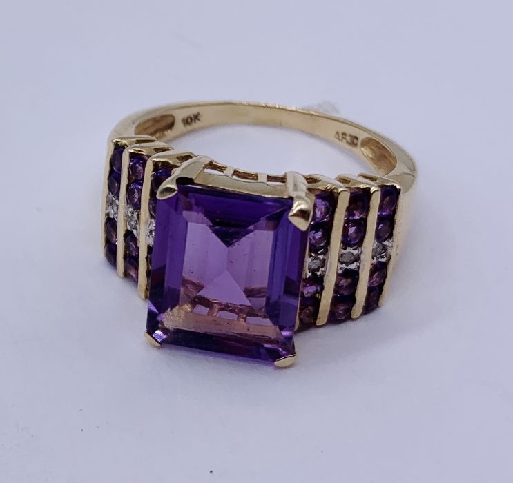 A large 10ct gold ring set with a central amethyst with diamond and amethyst shoulders - Image 2 of 4