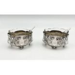A pair of French silver salts with shell-shaped glass spoons