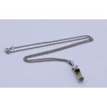 A 9ct white gold diamond and tourmaline pendant on matching chain, total weight 5.5g