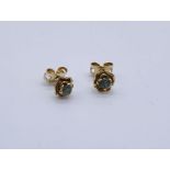 A pair of 9ct gold earrings set with Alexandrite