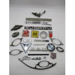 A collection of various car badges including BMW, Triumph, AA, Vauxhall, Saab 99, Subaru, Ford etc