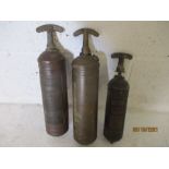 Three vintage fire extinguishers, two of which are marked as made by the Pyrene Company Ltd