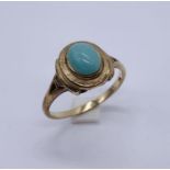 A 9ct gold ring set with turquoise cabochon