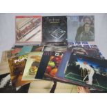 A small collection of 12" vinyl records including The Beatles, Supertramp, Simon & Garfunkel,