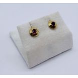 A pair of 18ct gold earrings set with rubies