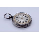 A hallmarked silver fob watch with silvered dial with gold detailing