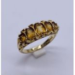 A 9ct gold ring set with 5 graduated Citrines